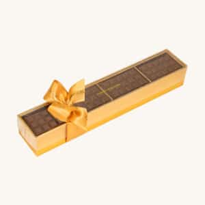 Sugar free mini chocolate tablets in a transparent gift box with a ribbon.