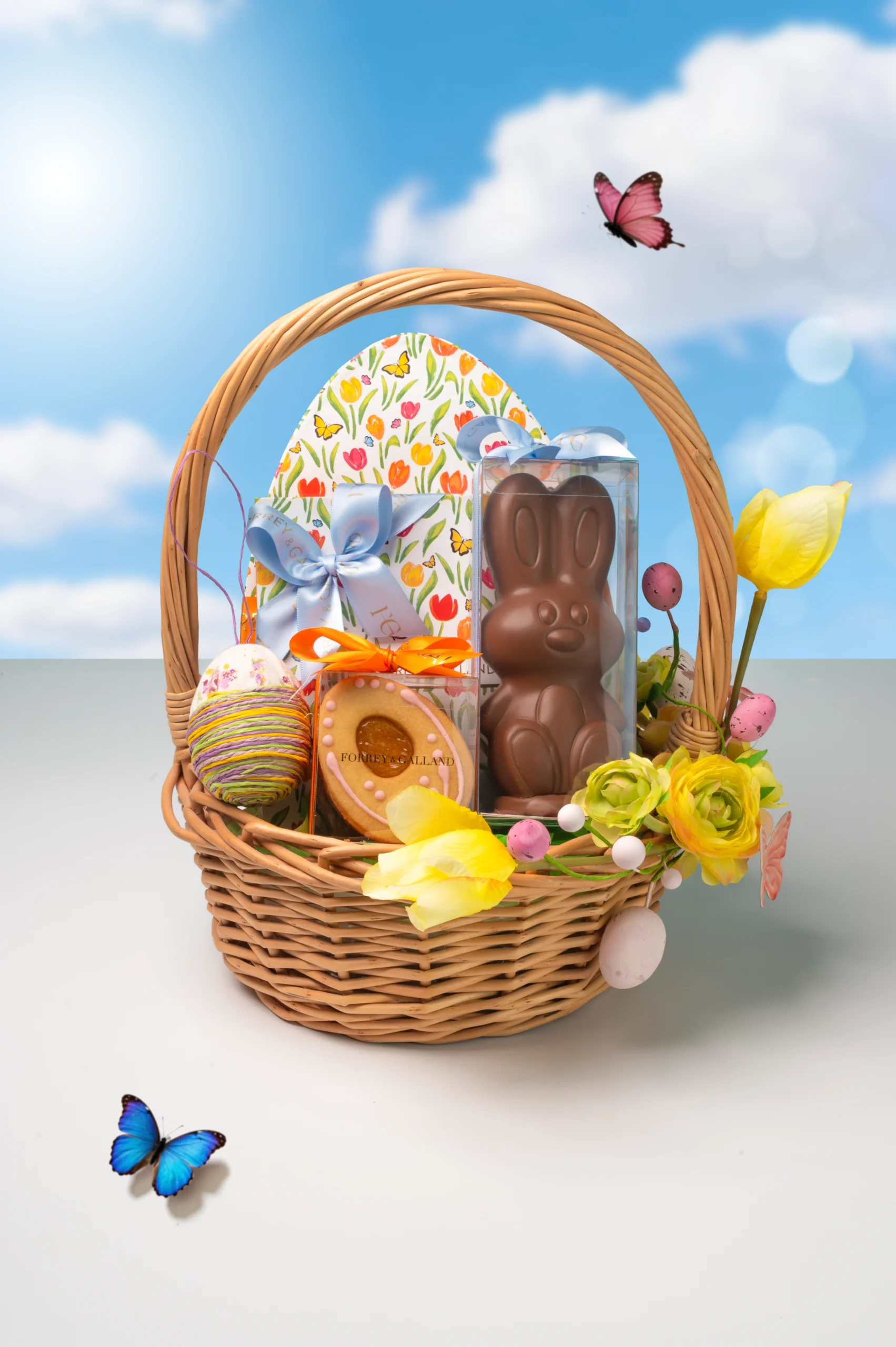Classic woven Easter basket with handcrafted chocolates cookies floral details and seasonal treats