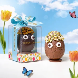 Handcrafted Easter chocolate egg with apricot finish and festive decoration