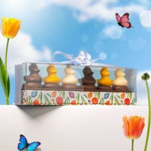 Handcrafted mini Easter chocolate ducks on chocolate-coated sable biscuits