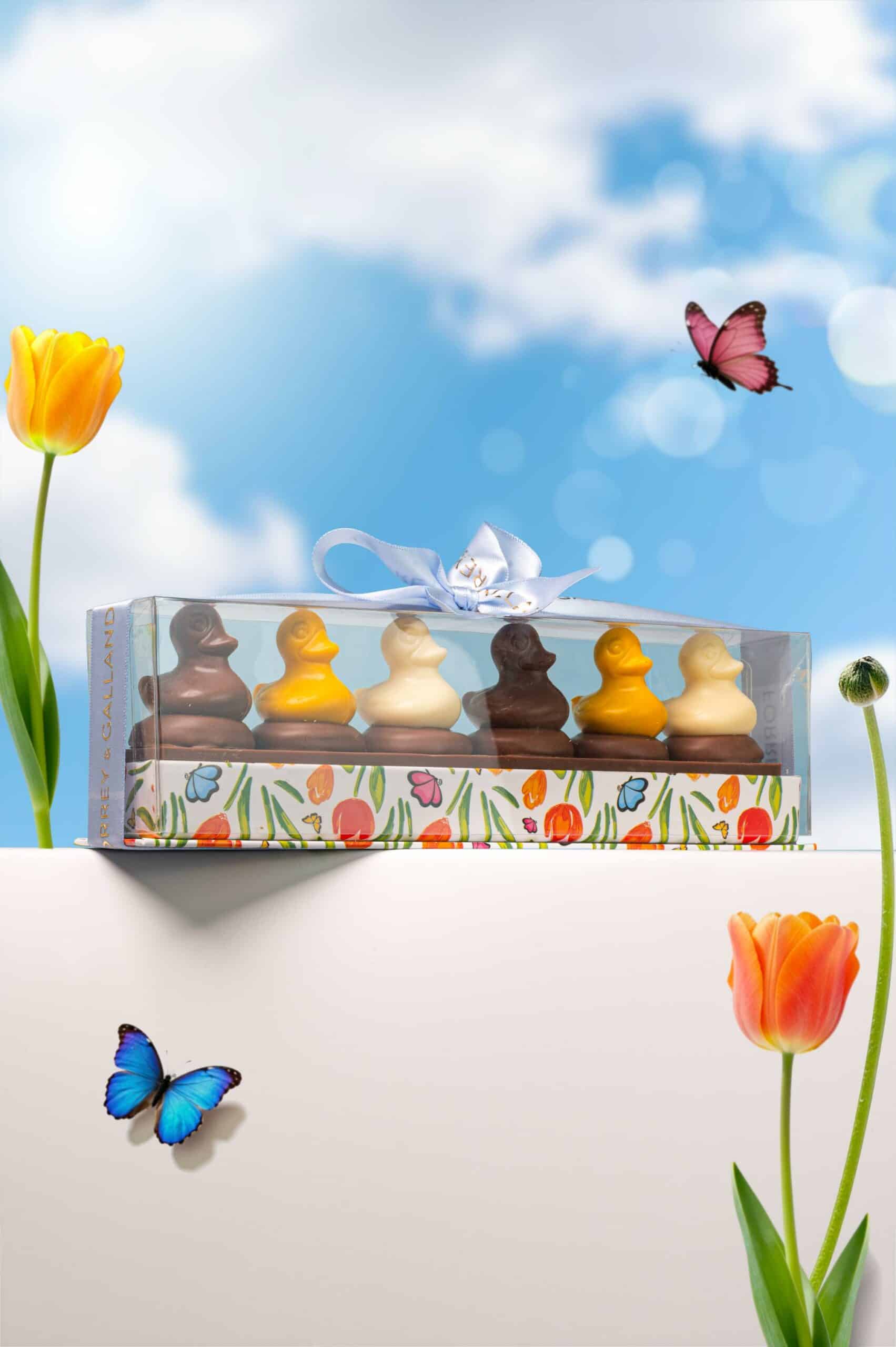 Handcrafted mini Easter chocolate ducks on chocolate-coated sable biscuits