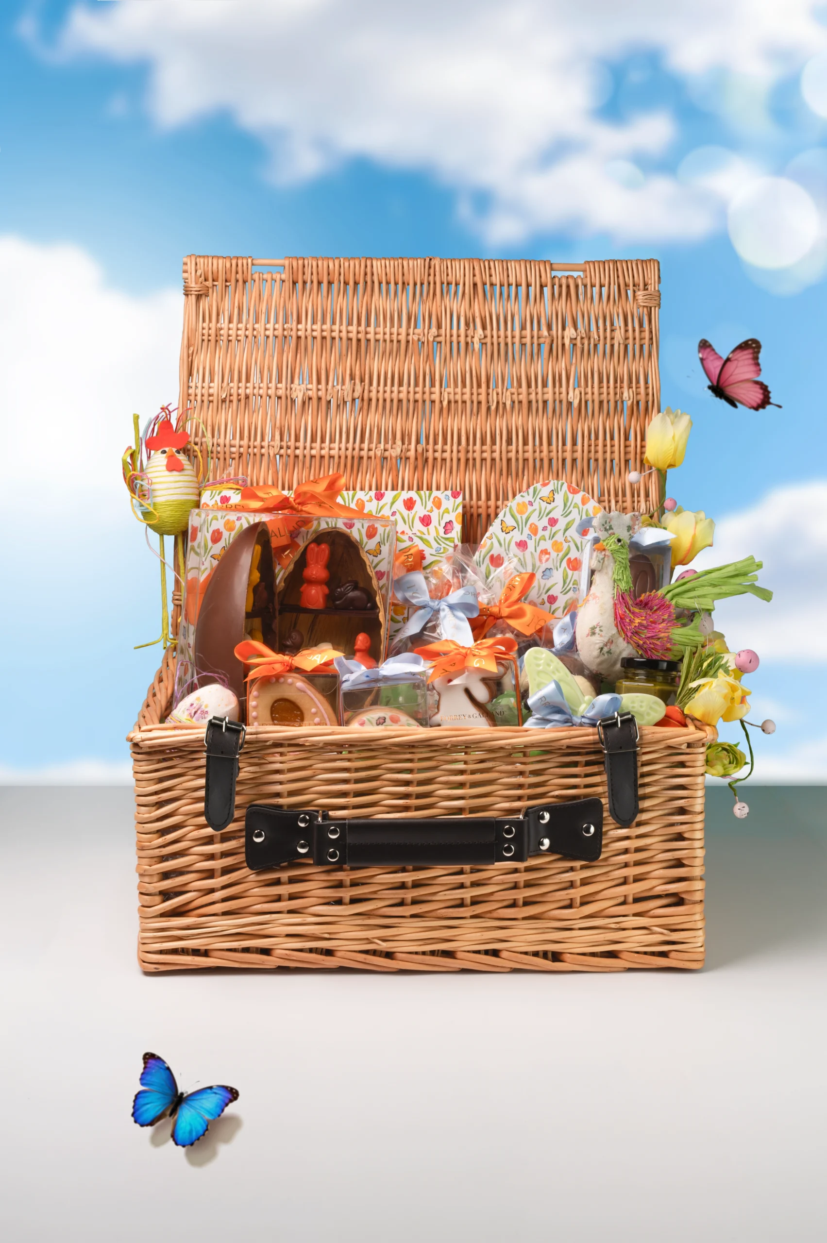 Large luxury Easter wicker hamper filled with handcrafted chocolates cookies and festive seasonal treats