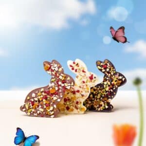 Handcrafted rabbit-shaped Easter chocolates topped with dried fruits and nuts