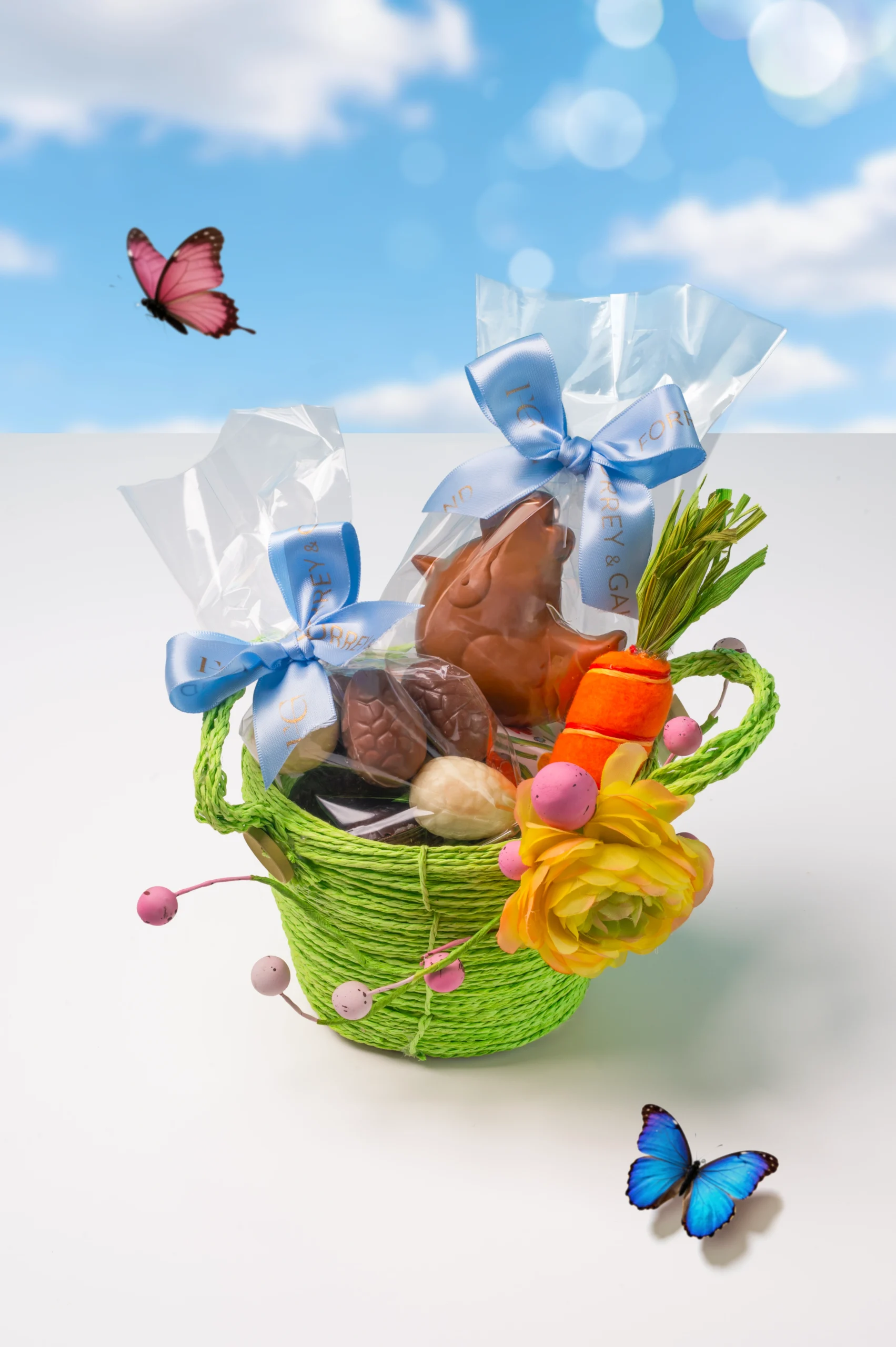 Small luxury Easter basket with handcrafted chocolates seasonal treats and spring floral details