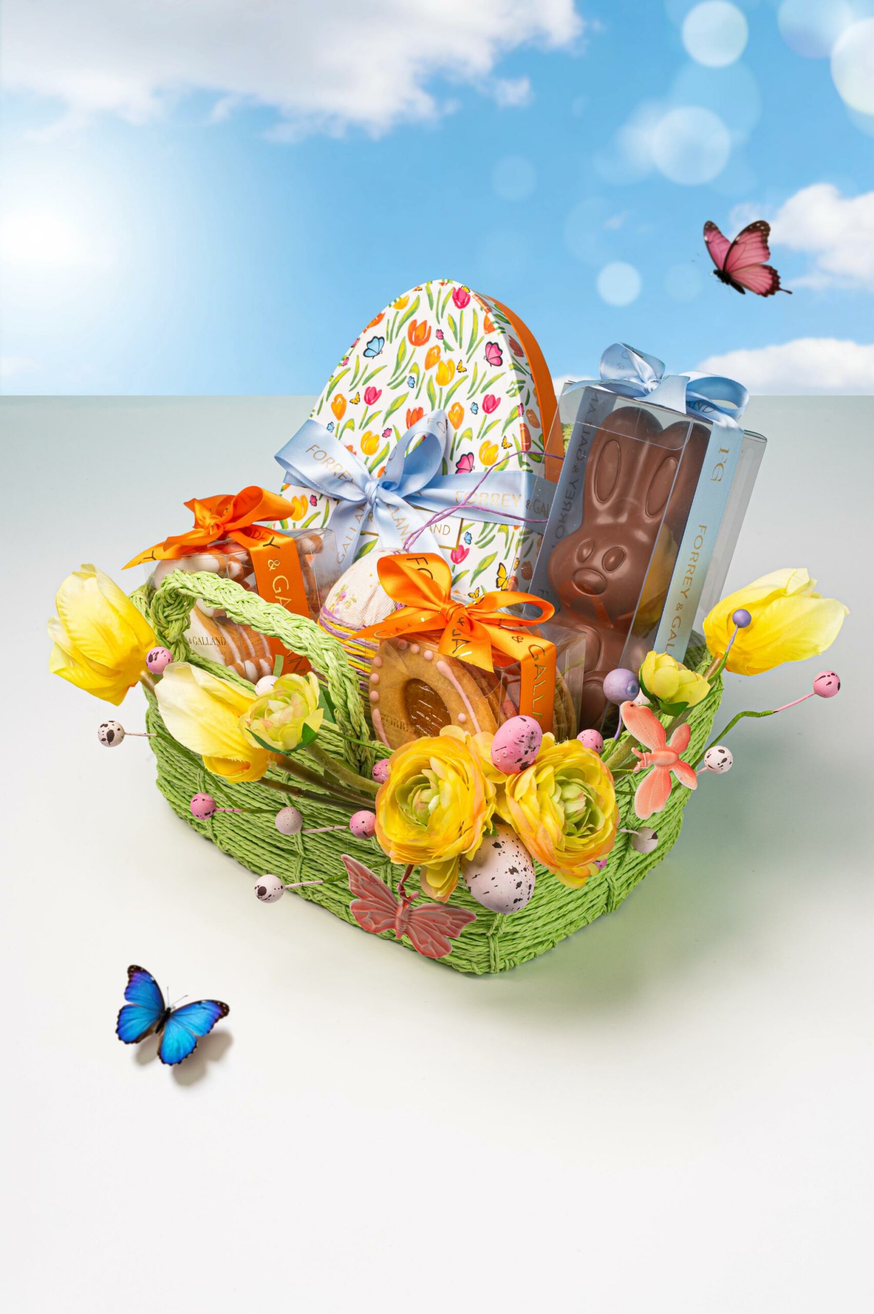 Classic woven Easter basket with handcrafted chocolates cookies floral details and seasonal treats