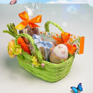 Luxury Easter hamper in a green woven basket with floral sleeve box handcrafted chocolates and seasonal treats